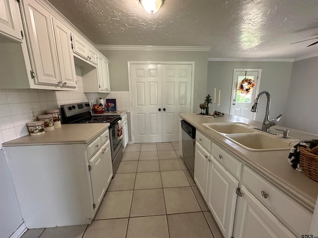 kitchen with light tile patterned flooring, stainless steel appliances, decorative backsplash, sink, and white cabinets