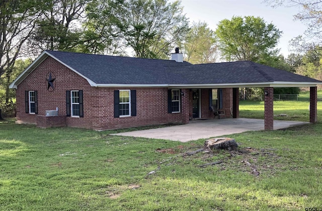 ranch-style home with a front yard and a patio area