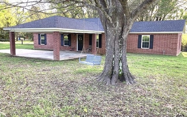 view of front of property with a front yard and a patio area