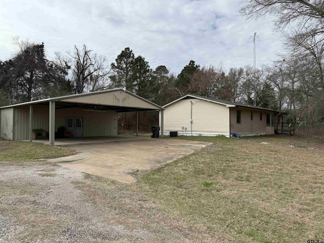 view of property exterior with a yard, central AC, and a carport