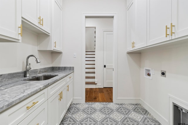 washroom with sink, cabinets, washer hookup, electric dryer hookup, and light tile patterned flooring