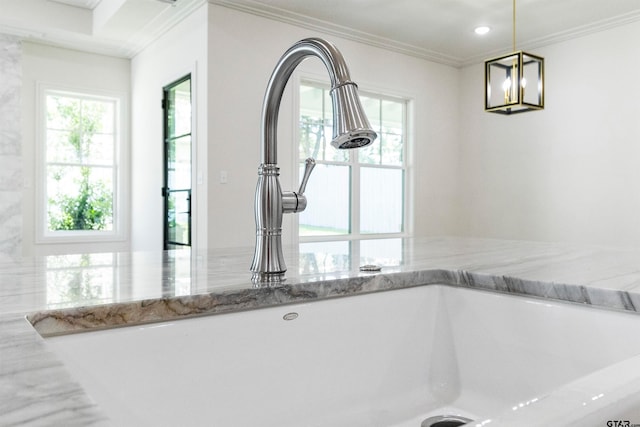 room details with pendant lighting, sink, light stone countertops, and ornamental molding