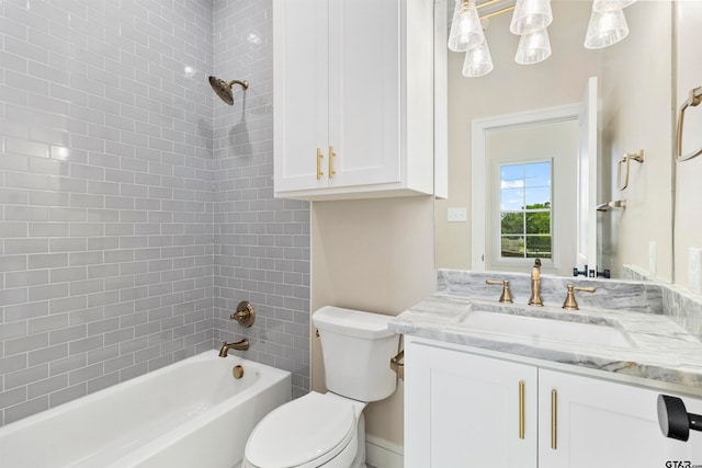 full bathroom with toilet, vanity, and tiled shower / bath