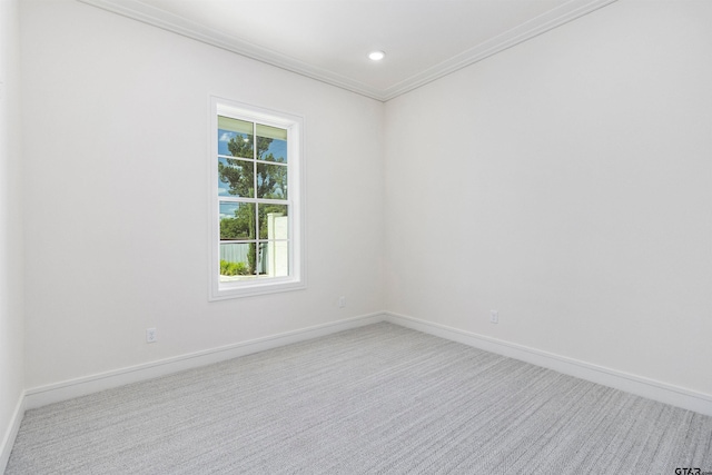 carpeted spare room featuring ornamental molding