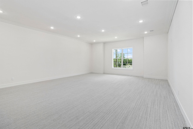 carpeted spare room featuring ornamental molding