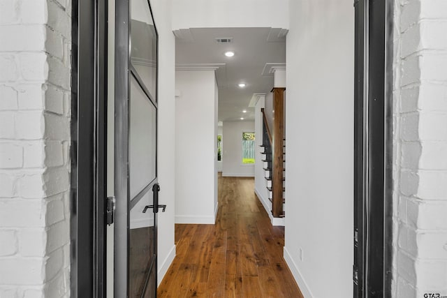 corridor featuring dark hardwood / wood-style floors and ornamental molding