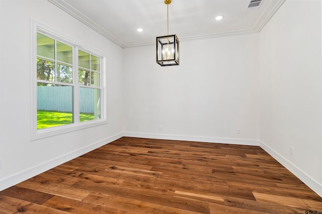 unfurnished dining area with dark hardwood / wood-style flooring, ornamental molding, and a chandelier