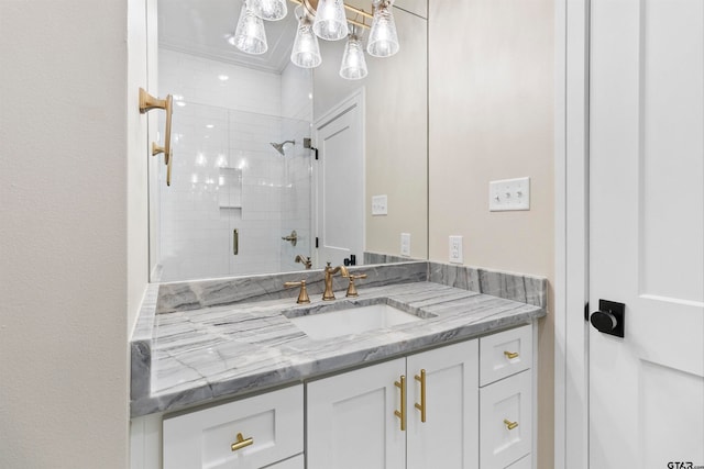 bathroom with vanity and a shower with door