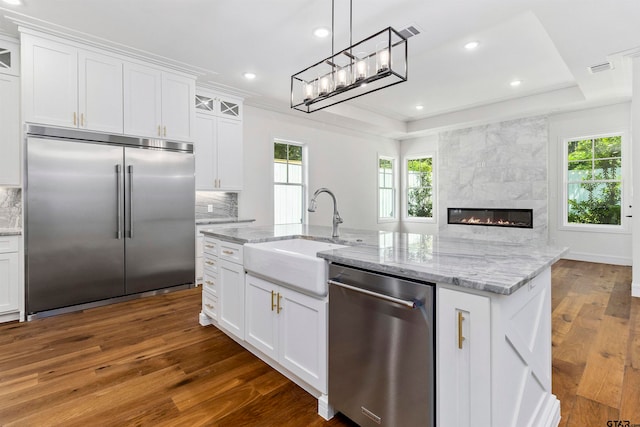 kitchen featuring a wealth of natural light, white cabinetry, dark wood-type flooring, and appliances with stainless steel finishes