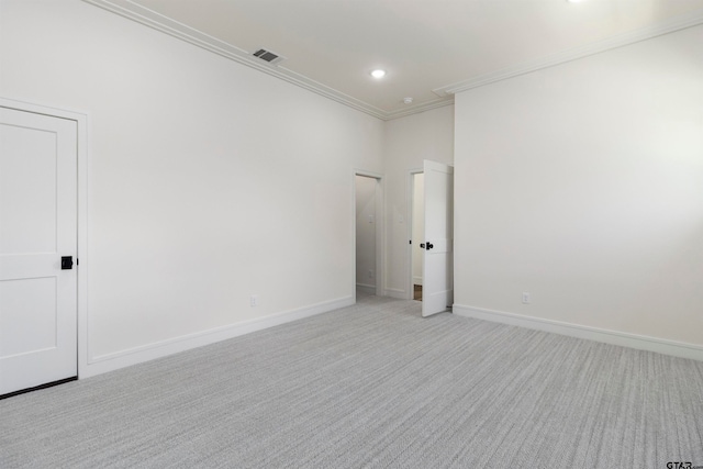 unfurnished room featuring light colored carpet and crown molding