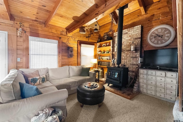 17044 Deer Run Dr, Bullard, TX 75757 - carpeted living area featuring a wood stove, wooden walls, and wood ceiling with exposed beams