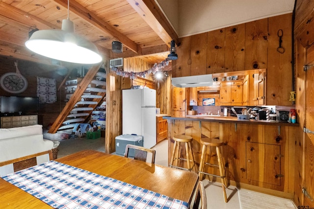 17044 Deer Run Dr, Bullard, TX 75757 - dining space with wooden walls, wooden ceiling with exposed beams, stairs, and light wood-type flooring