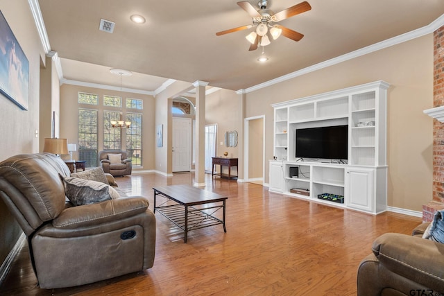 living room featuring ceiling fan with notable chandelier, light hardwood / wood-style flooring, and ornamental molding