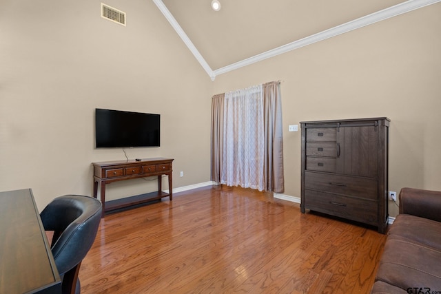 office area with ornamental molding, hardwood / wood-style floors, and high vaulted ceiling