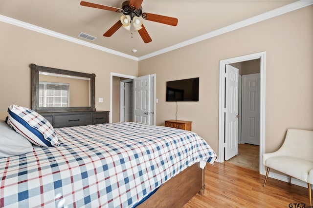 bedroom with ceiling fan, light hardwood / wood-style flooring, and crown molding