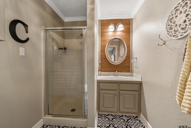 bathroom featuring a shower with door, vanity, and crown molding