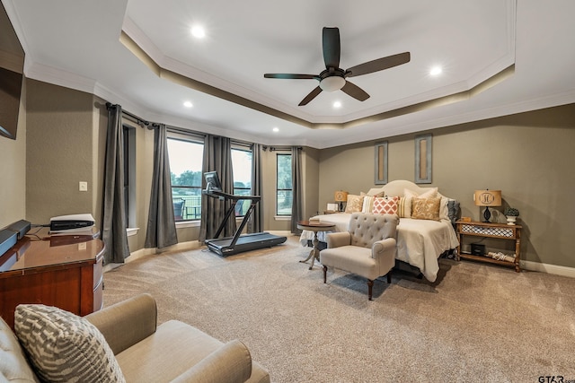 carpeted bedroom with ornamental molding, ceiling fan, and a raised ceiling