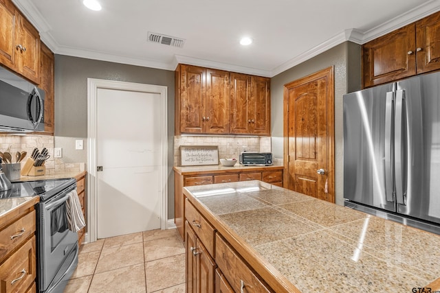 kitchen with light tile patterned floors, backsplash, appliances with stainless steel finishes, and ornamental molding