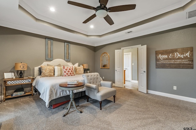 bedroom featuring ceiling fan, carpet flooring, a raised ceiling, and ornamental molding