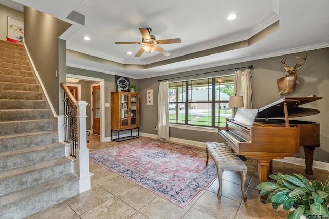 interior space featuring ornamental molding, light tile patterned flooring, and a tray ceiling