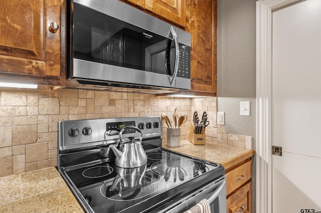 kitchen featuring decorative backsplash and stainless steel appliances