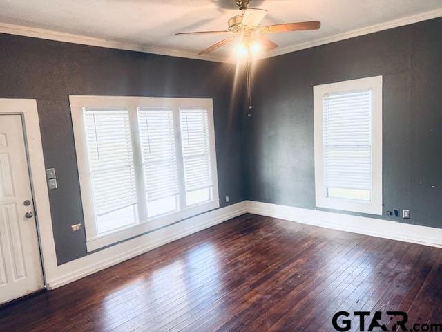 unfurnished room featuring ceiling fan, dark wood-type flooring, and crown molding