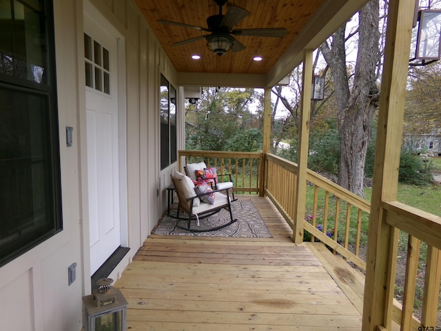 deck with ceiling fan and covered porch