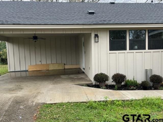 doorway to property with ceiling fan and a carport