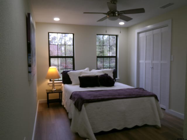 bedroom featuring ceiling fan, a closet, and dark hardwood / wood-style floors