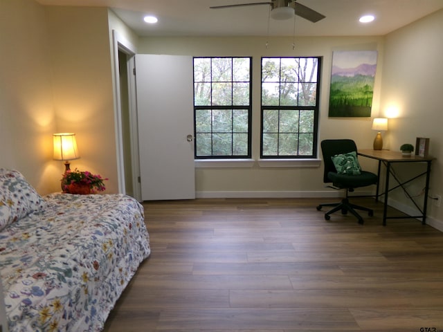 bedroom with ceiling fan and hardwood / wood-style flooring