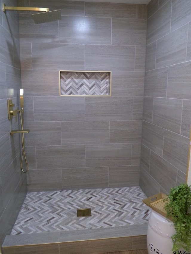 bathroom with a tile shower