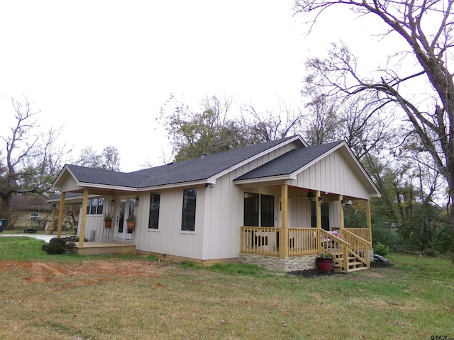 view of front of property with covered porch and a front yard