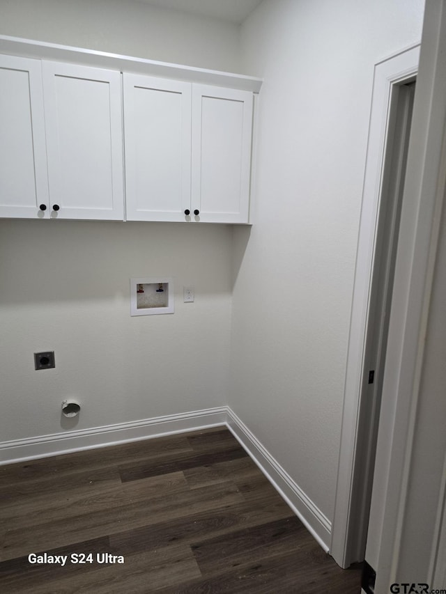 laundry room featuring cabinet space, hookup for a washing machine, dark wood finished floors, electric dryer hookup, and baseboards