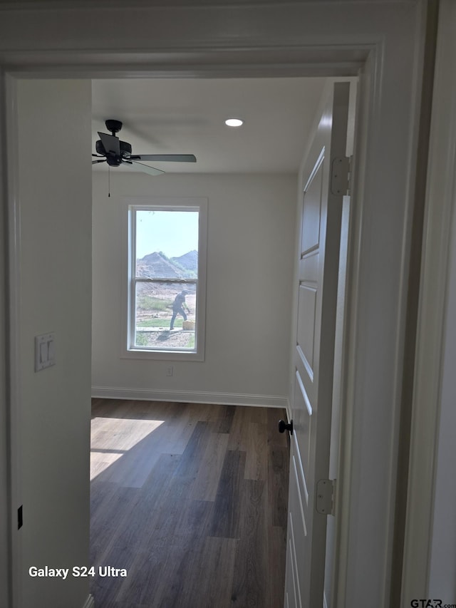 spare room with baseboards, a ceiling fan, recessed lighting, and dark wood-type flooring
