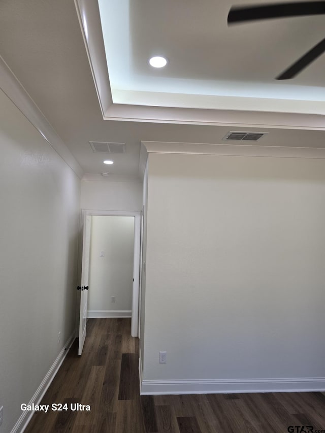 hallway with visible vents, recessed lighting, and dark wood-type flooring