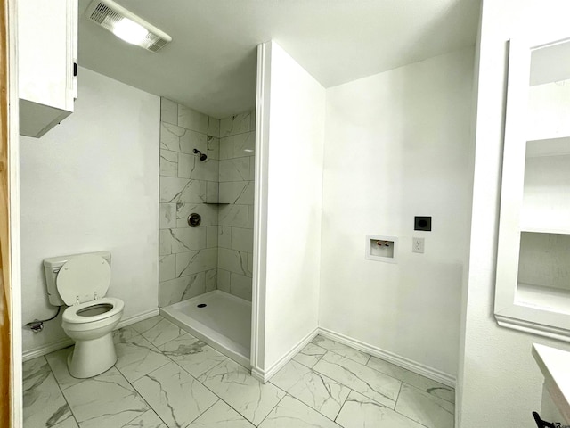 bathroom with toilet and tiled shower