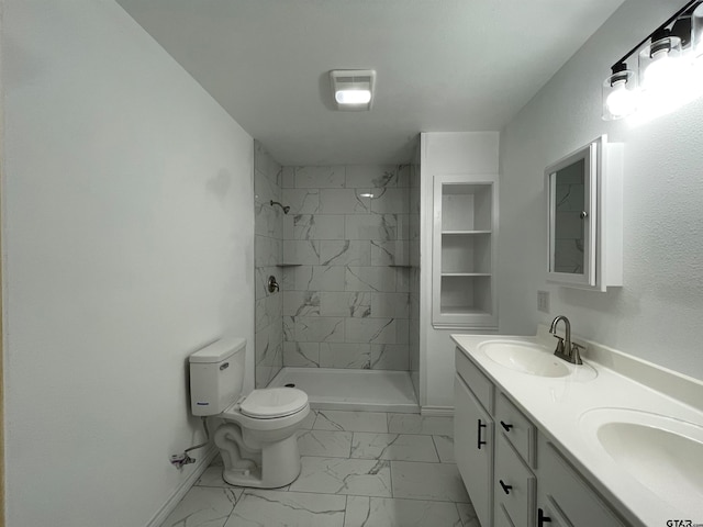 bathroom featuring tiled shower, toilet, and vanity