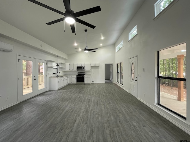 unfurnished living room with sink, high vaulted ceiling, ceiling fan, dark hardwood / wood-style floors, and an AC wall unit