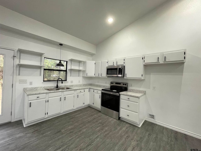 kitchen featuring dark hardwood / wood-style flooring, white cabinets, sink, appliances with stainless steel finishes, and decorative light fixtures