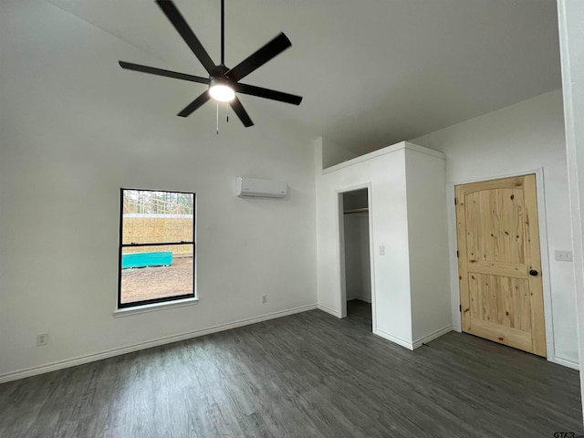 unfurnished bedroom featuring a wall mounted AC, ceiling fan, and dark hardwood / wood-style floors