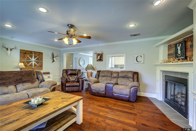 356 County Road 1439, Sulphur Springs, TX 75482 - living room with a tiled fireplace, visible vents, wood finished floors, ceiling fan, and ornamental molding