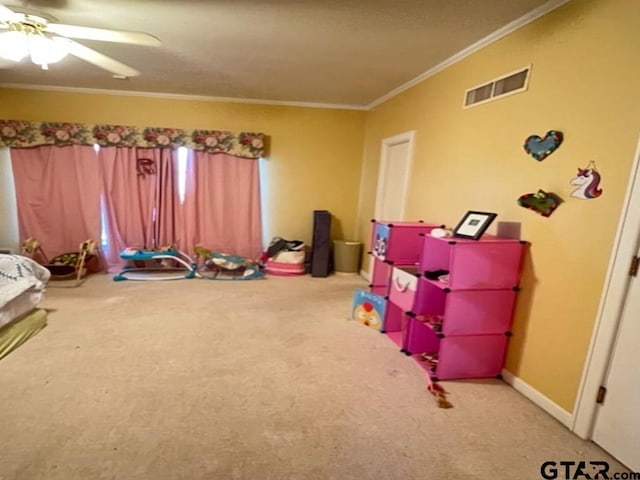 game room with crown molding, carpet floors, and ceiling fan