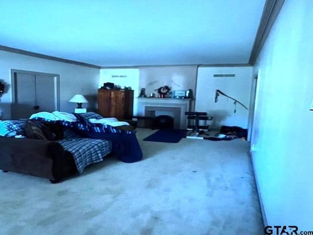 carpeted bedroom with crown molding and a fireplace