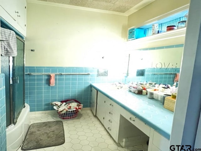 bathroom featuring vanity and tile walls