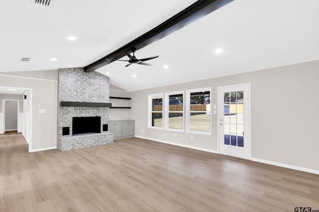 unfurnished living room featuring a fireplace, vaulted ceiling with beams, light wood-type flooring, and ceiling fan