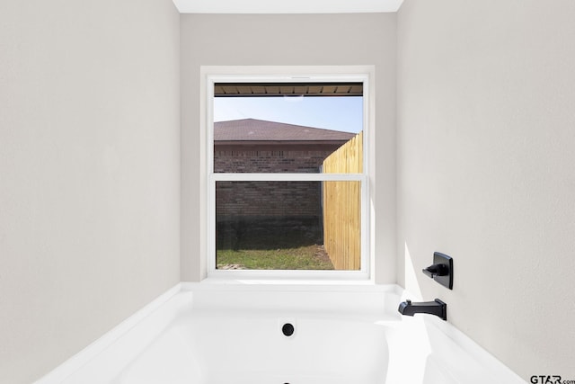 bathroom featuring a bathtub and plenty of natural light