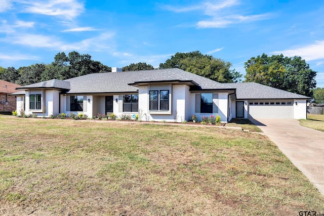 view of front facade with a front yard and a garage