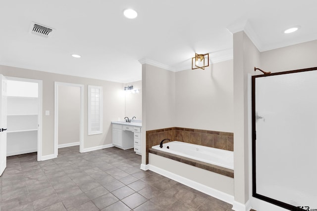 bathroom with tile patterned floors, vanity, a relaxing tiled tub, and ornamental molding