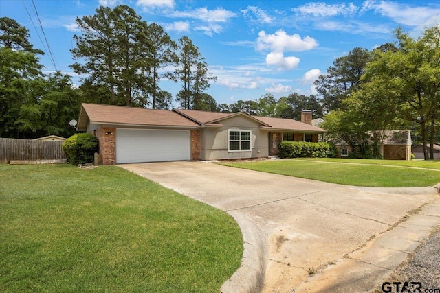 303 Westwood Dr, Troup, TX 75789 - single story home featuring an attached garage, concrete driveway, a chimney, and brick siding