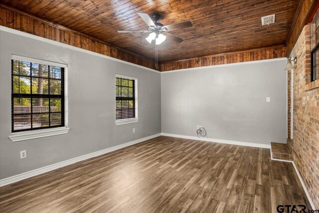 303 Westwood Dr, Troup, TX 75789 - unfurnished room with wood ceiling, wood finished floors, baseboards, a ceiling fan, and brick wall
